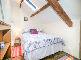 A bedroom with a bed and side table at Brynffynon in Pwllheli