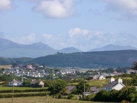 A landscape view featuring houses and mountains at Brynffynon in Pwllheli