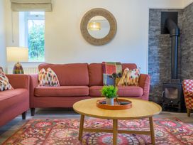 A living room with a sofa and a lamp at Moss Crag in Glenridding