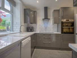 A kitchen with modern cabinets and appliances at Moss Crag in Glenridding