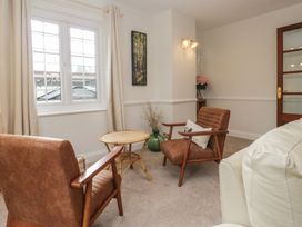 A living room with chairs and a table at Cumbria house