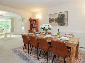 A dining area with a wooden table and chairs at Cumbria house