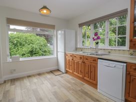 A kitchen with fridge, sink and dishwasher at Cumbria house