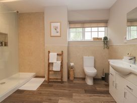 A bathroom with a shower, toilet, and sink at Cumbria house