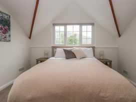 A bedroom with a bed and two bedside tables at Cumbria house