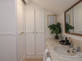 A bathroom with a sink and wardrobe at Cumbria house