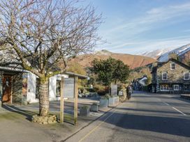 An outdoor view with buildings and mountains at Cumbria house