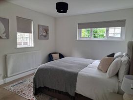 A bedroom with a bed, bedside table, and window at Cumbria house Grasmere