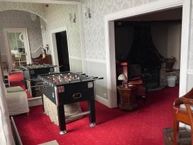 A game room with a foosball table and seating at Noddfa Country House Harlech