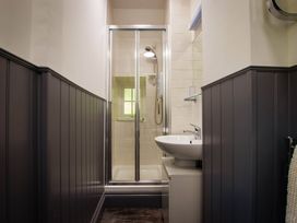 A bathroom with a shower and sink at Noddfa Country House in Harlech