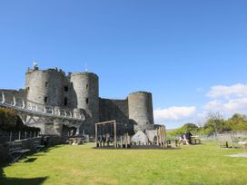 An outdoor area with a castle and playground equipment at Noddfa Country House in Harlech