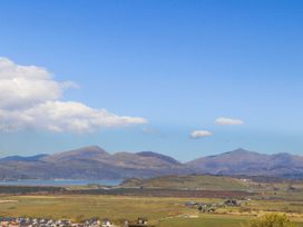 A landscape view of mountains and houses at Noddfa Country House in Harlech