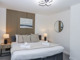 A bedroom with a bed and lamps at Milana in Tiverton