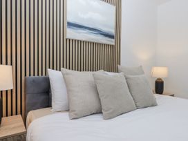A bedroom with pillows and lamps at Milana in Tiverton