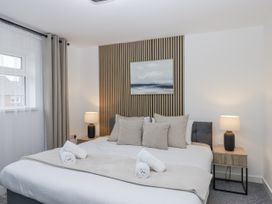 A bedroom with a bed and bedside lamps at Milana in Tiverton