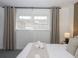 A bedroom with a window and bedding at Milana in Tiverton