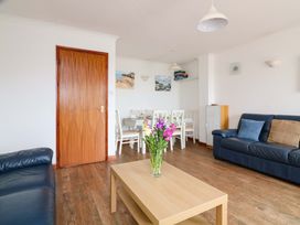 A living room with a table and chairs at Surf View in Hope Cove