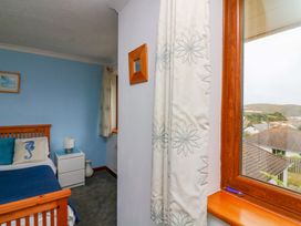 A bedroom with a bed and bedside table at Surf View in Hope Cove