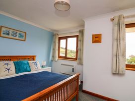 A bedroom with a bed and window at Surf View in Hope Cove