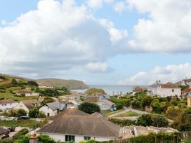A coastal view with houses and hills at Surf View in Hope Cove