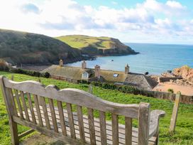 A coastal view from a bench overlooking the sea at Surf View in Hope Cove
