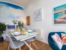 A dining room with a table set for meals at Penthouse @46Zinc - Headland View Newquay