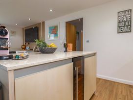 A kitchen with a coffee machine and a bowl of fruit at Penthouse @46Zinc - Headland View in Newquay