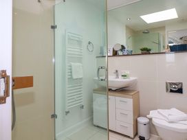 A bathroom with a shower, sink, and toilet at Penthouse @46Zinc - Headland View, Newquay