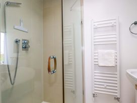A shower with towel rail and sink at Penthouse @46Zinc - Headland View, Newquay