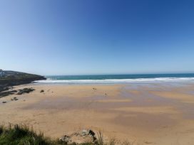 A beach with sand and waves at Penthouse @46Zinc - Headland View Newquay