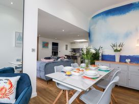 A dining room with a table and chairs at Penthouse @46Zinc - Headland View, Newquay