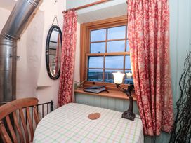 A dining area with a table and chair at Sammy Hakes Cottage