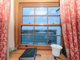 A window with a view of a harbor at Sammy Hakes Cottage 