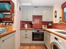 A kitchen with cupboards and appliances at Sammy Hakes Cottage