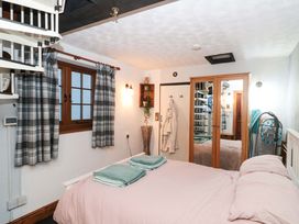 A bedroom with a bed and wardrobe at Sammy Hakes Cottage