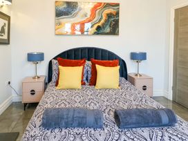 A bedroom with a bed and bedside tables at Bronallt in Cemaes Bay