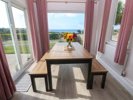 A dining room with a table and flowers at St Marys in Penzance