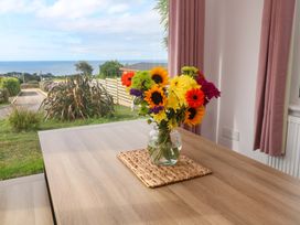 A dining room with flowers on a table at St Marys in Penzance