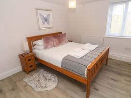 A bedroom with a double bed and bedside table at St Marys in Penzance
