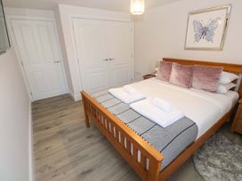 A bedroom with a bed and two doors at St Marys in Penzance