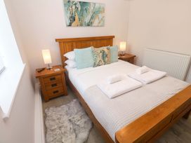 A bedroom with a bed and bedside tables at St Marys in Penzance