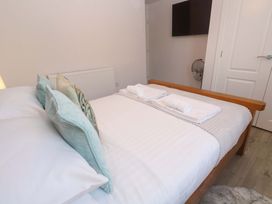 A bedroom with a bed and towels at St Marys in Penzance