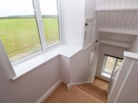 A staircase with a window and door at St Marys in Penzance