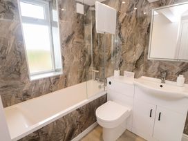 A bathroom with a bathtub, toilet, sink and window at St Marys Penzance