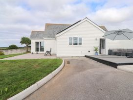 An outdoor area with a house, garden, and a patio furniture set at St Marys in Penzance
