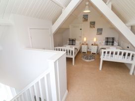 A bedroom with two beds and lamps at St Marys in Germoe