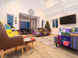 A living room with a sofa and television at St Marys in Praa Sands