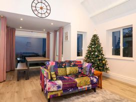 A living room with a sofa and a Christmas tree at St Marys in Praa Sands
