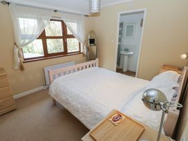 A bedroom with a bed and a window at Riverside Lodge 3