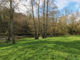 A landscape with trees and a river at Riverside Lodge 3